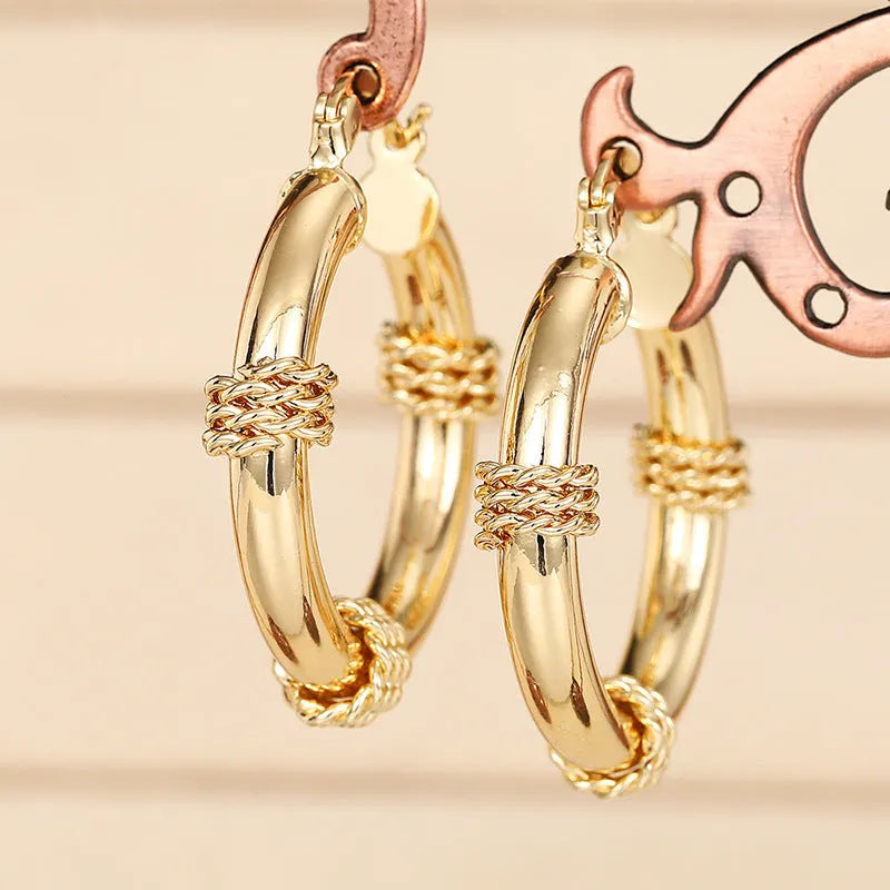 Geometric copper ear clips with ring and line patterns in three golden finish options