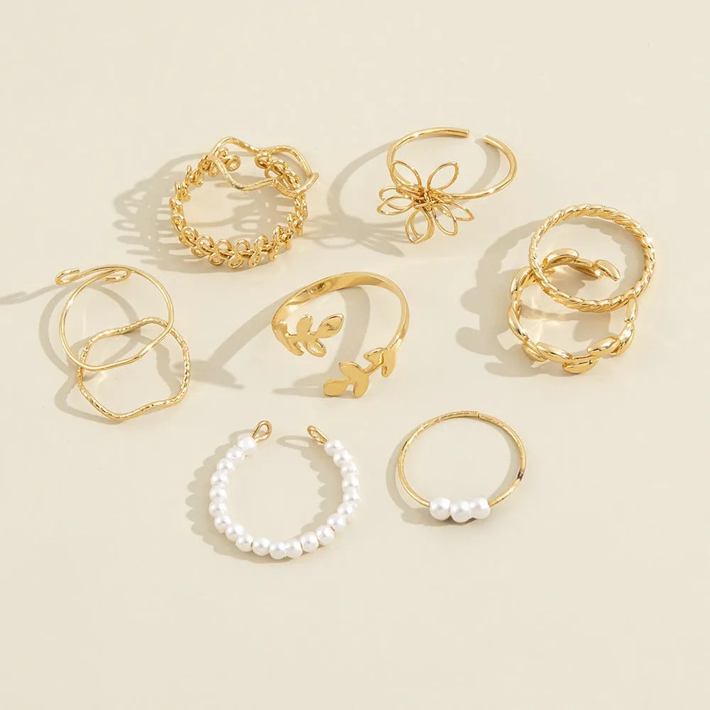 Gold coloured openwork flower shape alloy ring with a glossy electroplated finish.