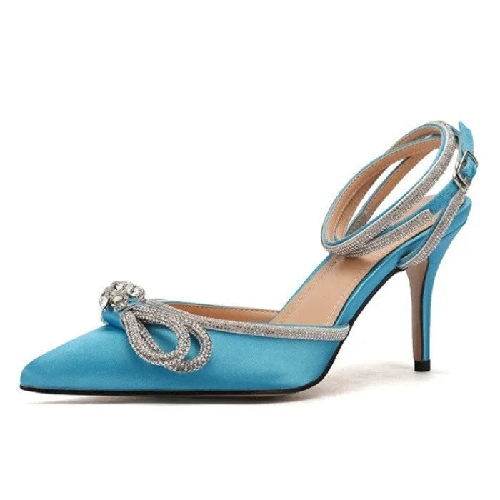 Women's black stiletto heel sandals with a silk bandage strap and buckle fastening on a pointed toe.