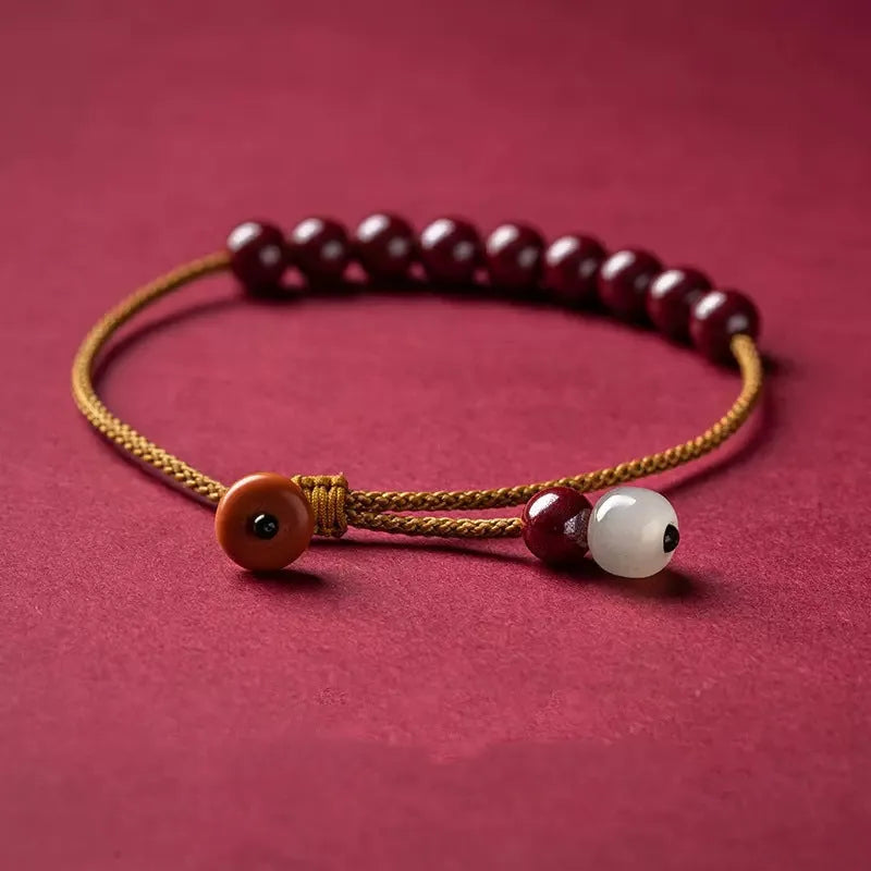 Hand-woven geometric bracelet made from raw red cinnabar ore on an adjustable cord.