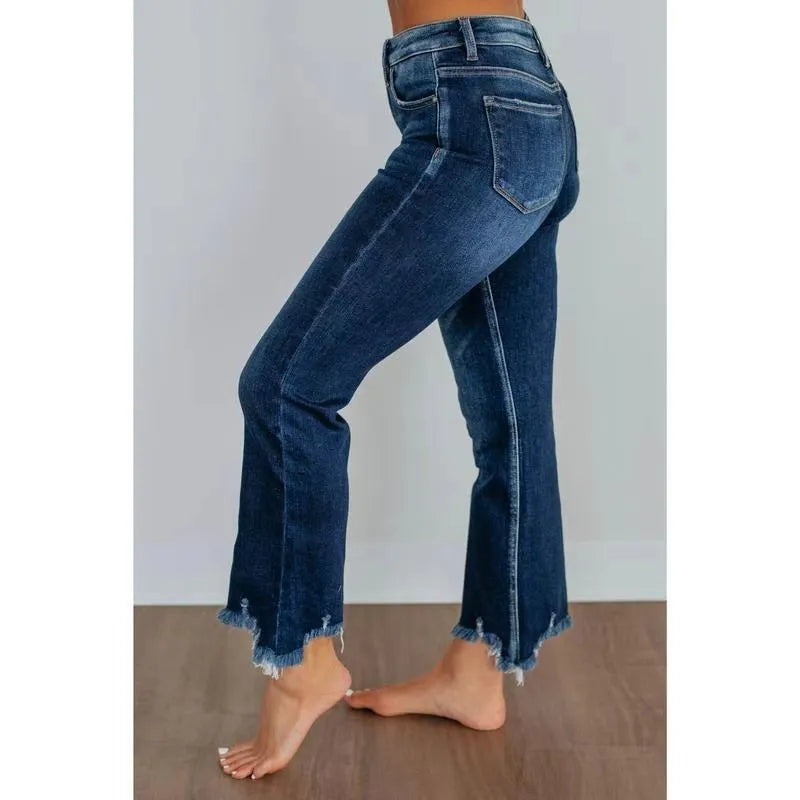 Women's dark blue casual denim jeans with hand-worn distressing on a solid cotton fabric