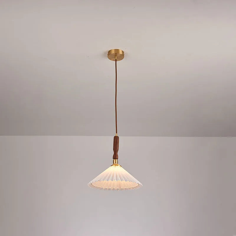American Retro style wooden wall lamp with copper accents and a white fabric shade mounted above a bedside table.
