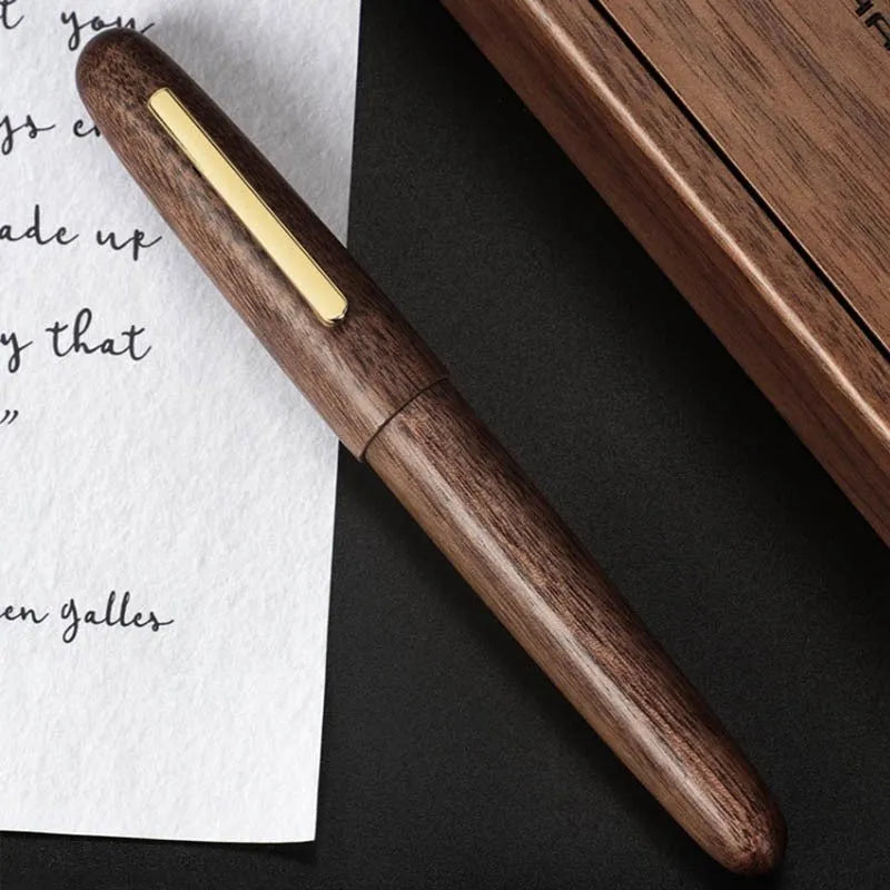 Wooden fountain pen with a rotating cap on a wooden desk, showing choice of rosewood and ebony bodies with different nibs.