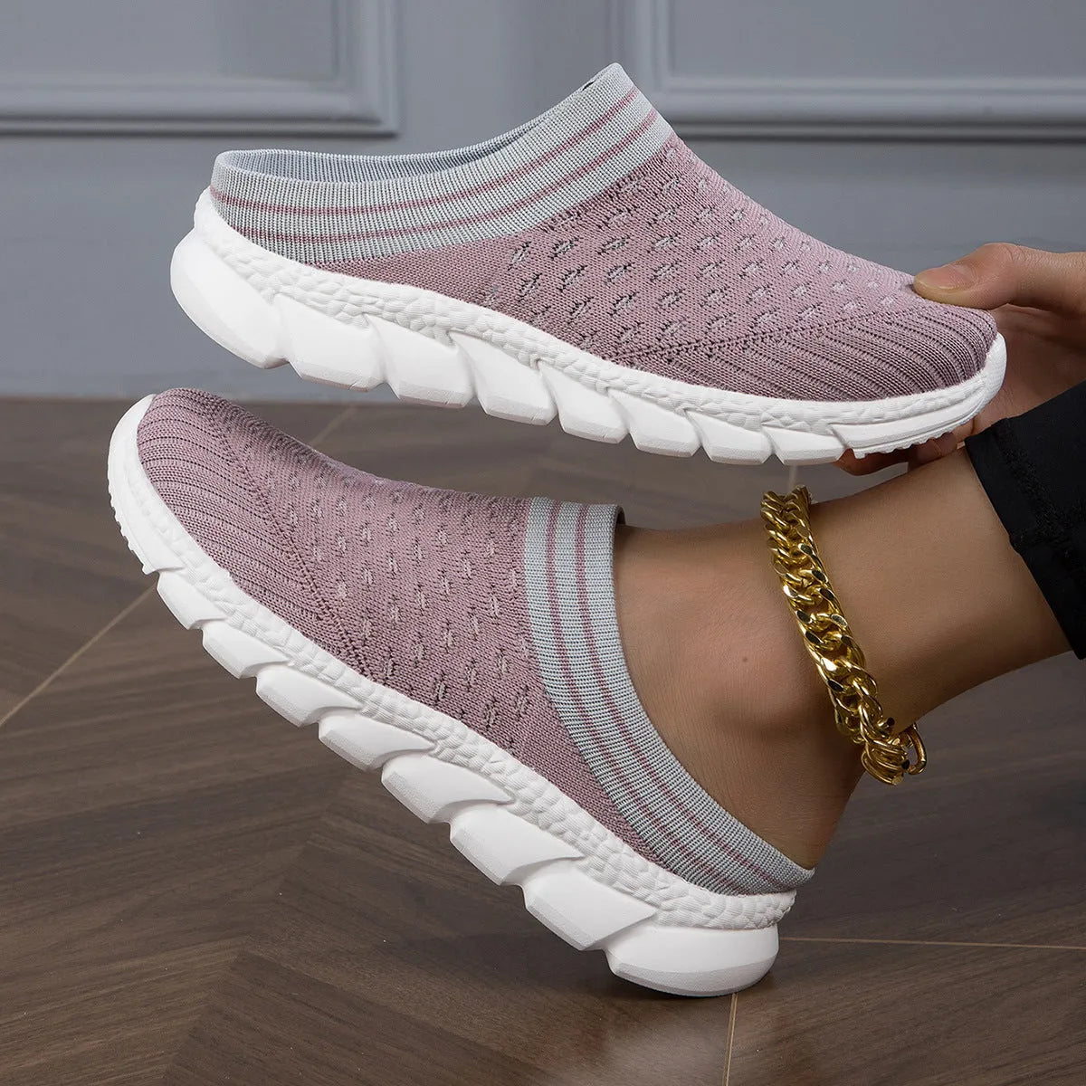 Women's black flyknit slippers with hollowed-out pattern and a height-increasing viscose sole.