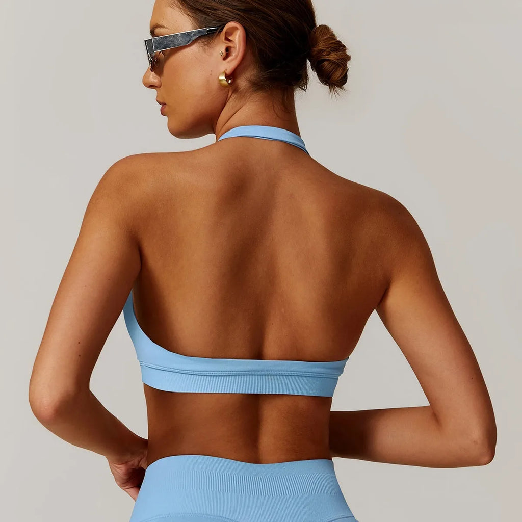 Women's black halter neck yoga sports bra with a removable padded insert.