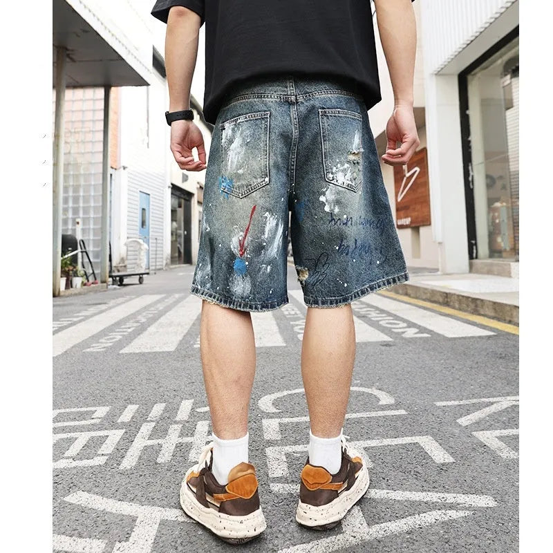Blue men's ripped denim shorts with a straight leg cut and zip fly front.