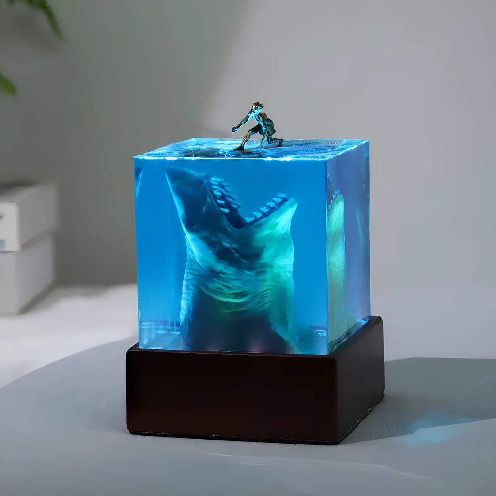 Clear epoxy resin night light ornament with a shark surfer scene inside, shown in 5cm and 8cm sizes.
