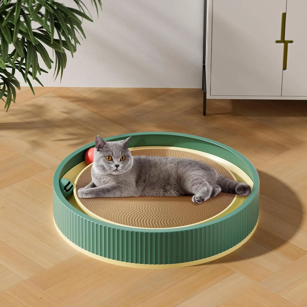 Large green circular cardboard cat scratching board with built-in track balls and a spring plush ball toy.
