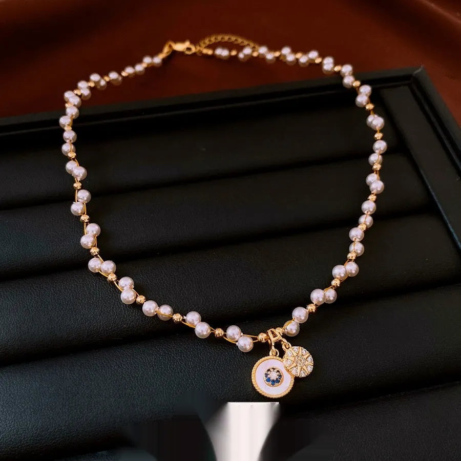 Gold electroplated round pendant necklace with inlaid zircon stone on a clavicle chain