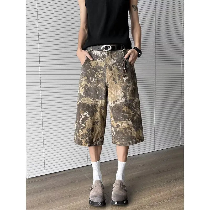 Women's yellow snake pattern camouflage print cropped denim jeans laid flat.