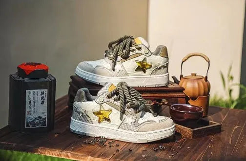 Green low-top casual trainers with star pattern stitching and lace-up closure
