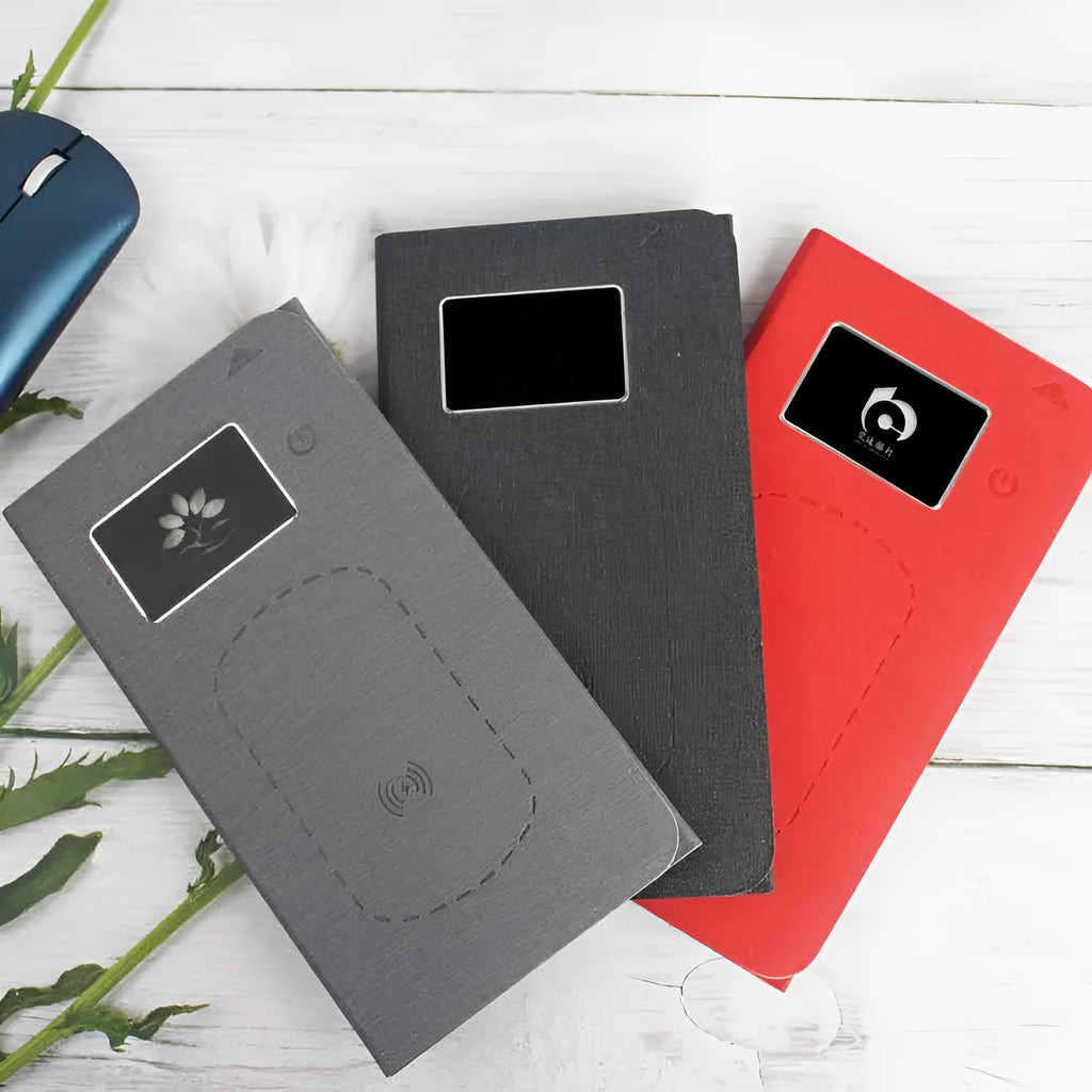 Folding wireless charging mouse pad set with separate Bluetooth mouse on a desk.