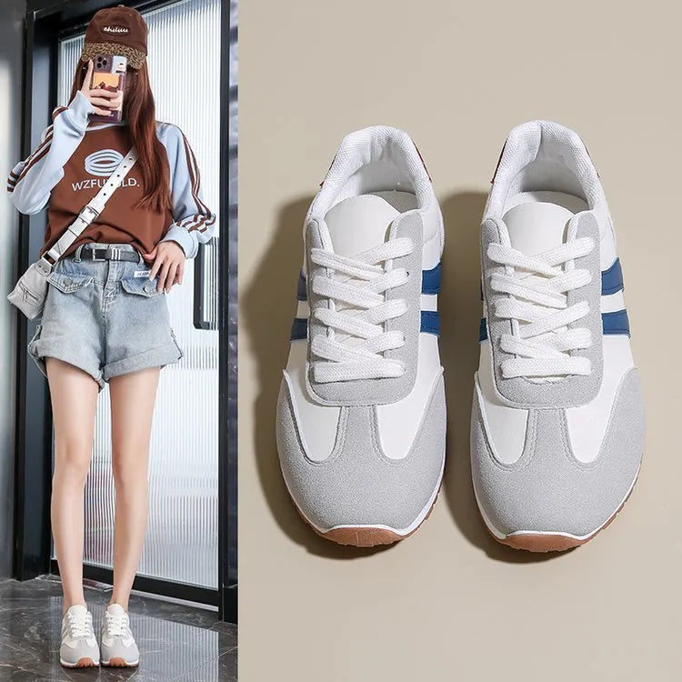 Blue and grey leisure sports shoes with Cortez stripes pattern, round toe, and flat rubber sole.