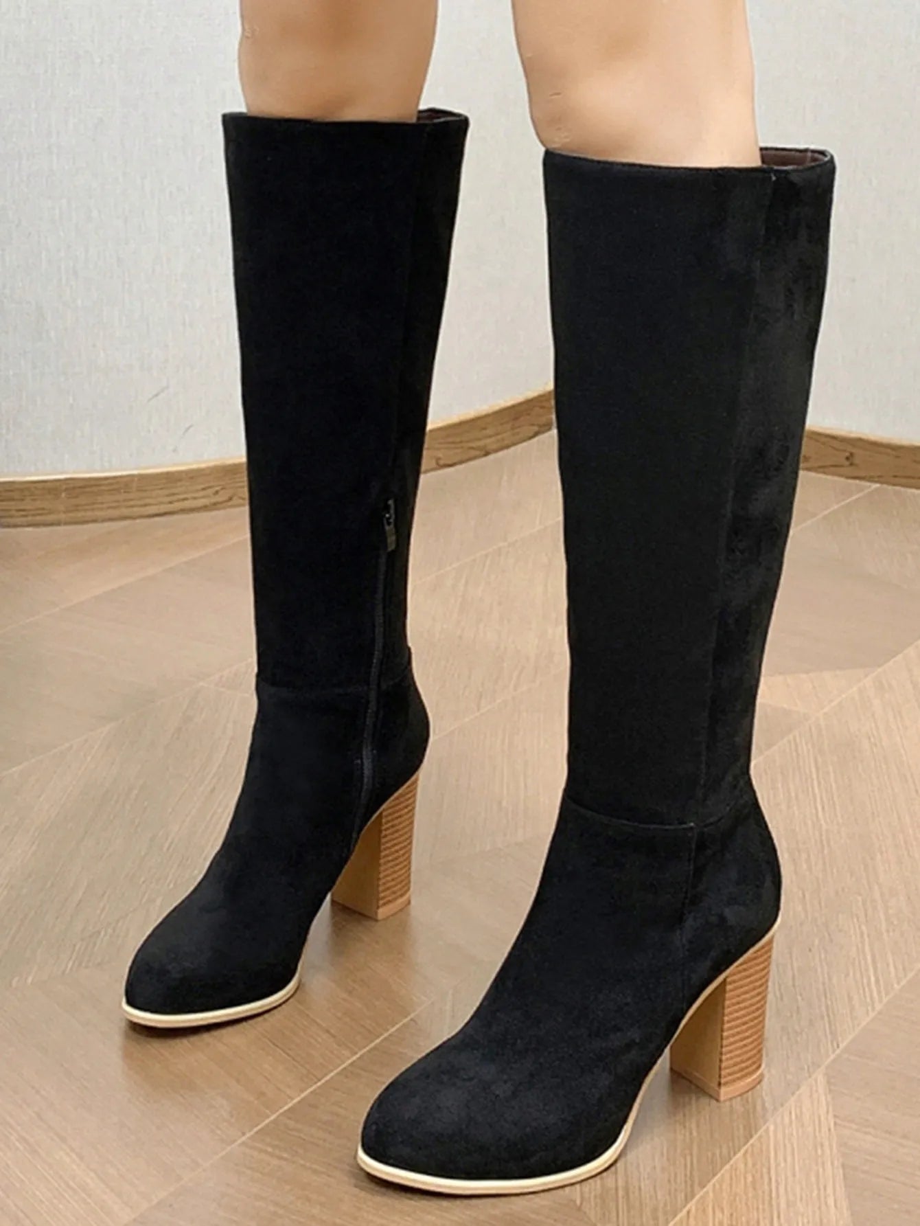 Women's black square toe high heel fashion boots made from artificial PU leather.
