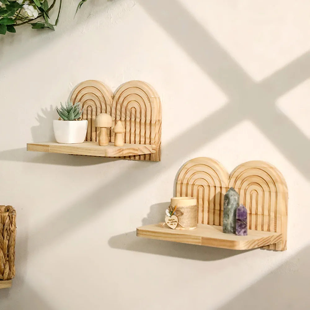 Solid wood multi-layer wall-mounted shelf holding several small potted plants.