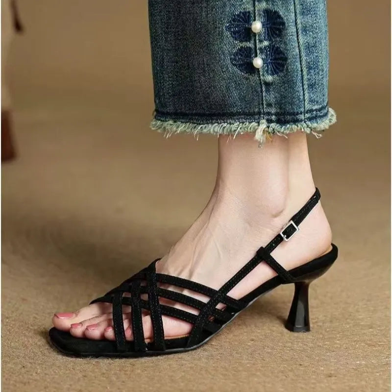 Retro women's sandals with thin cross straps, ankle buckle, square toe, and a mid heel.