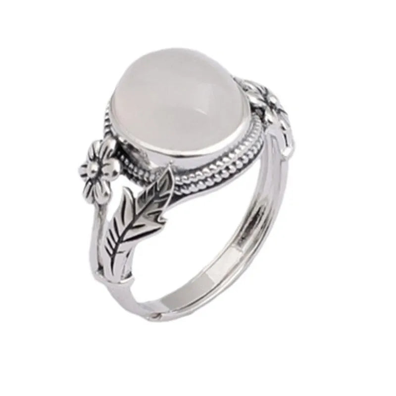 Antiqued copper ring with white stone and adjustable U-shaped opening.