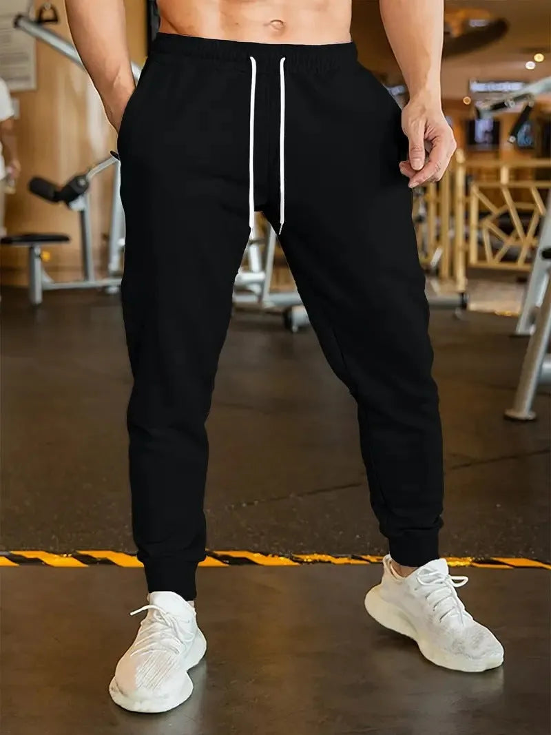 Men's loose-fit linen-style leisure trousers with an elastic drawstring waistband, shown in a neutral colour.