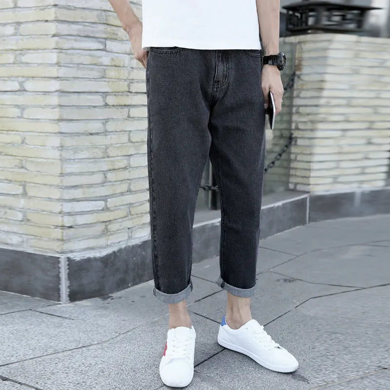 Men's black straight leg jeans with loose harem fit and cotton fabric construction