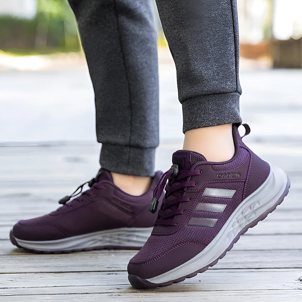 Men's and women's black mesh slip-on casual shoes with an elastic band across the instep.