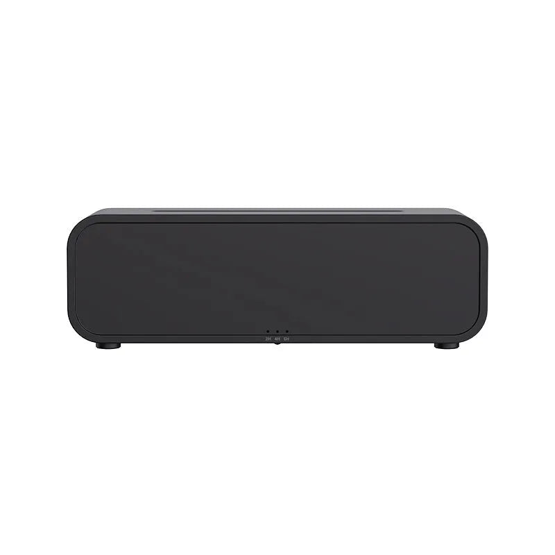 Black aromatherapy diffuser with colour-changing lights and remote control on table