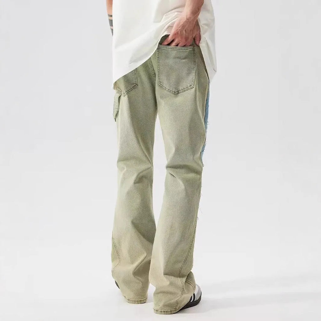 Yellow and blue retro jeans with patchwork and splash-ink damaged design, mid-waist cut.
