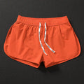Men's loose orange red polyester beach trousers for surfing and swimming on a summer day.