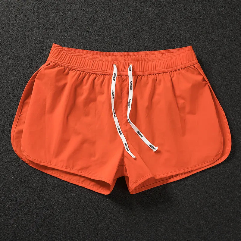 Men's loose orange red polyester beach trousers for surfing and swimming on a summer day.
