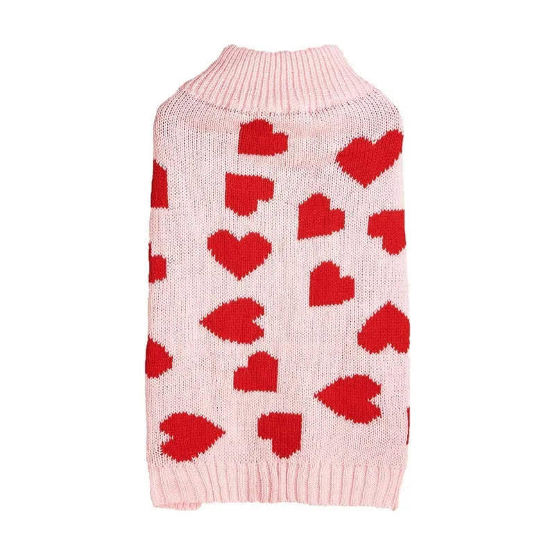 Red dog sweater with a white love heart and bow decoration on a small dog.