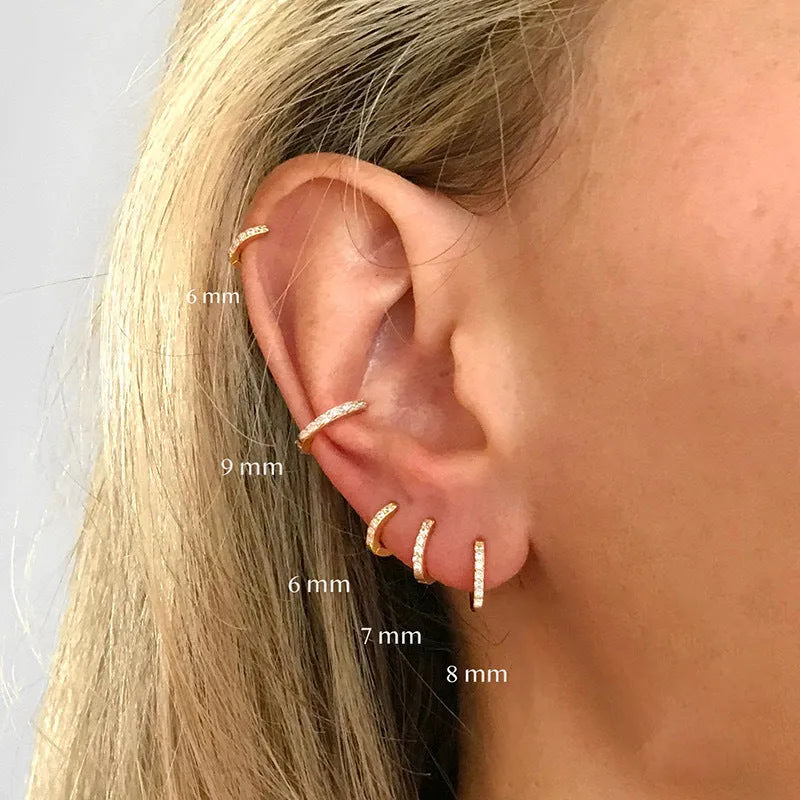 Gold, rose gold, and silver circle stud earrings with a perforated geometric design and zircon detail.