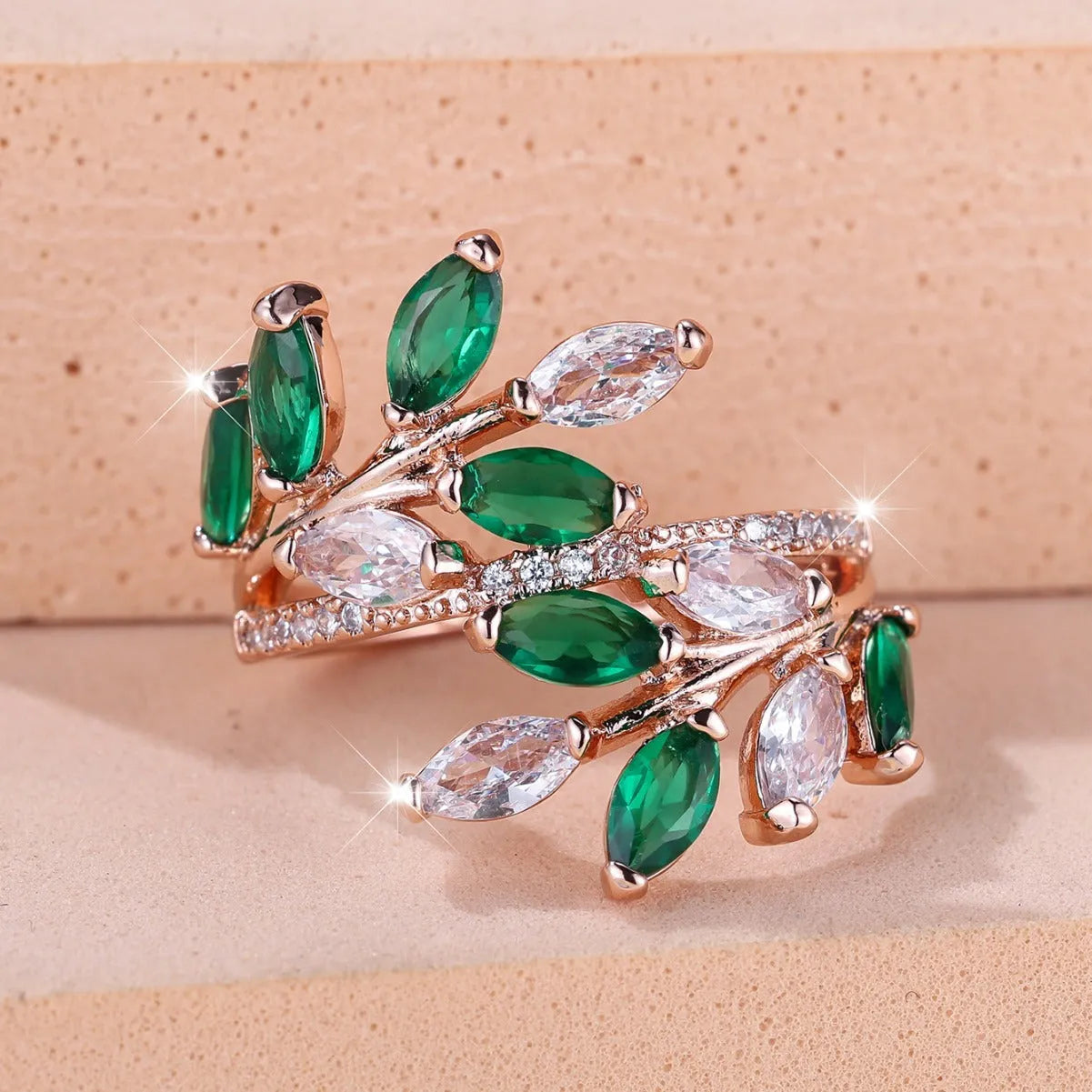 Adjustable copper leaf ring with zircon detailing in multiple colour options on display