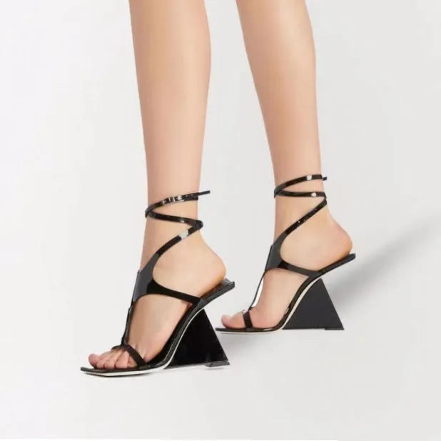 Women's black square-toe high heel sandals with a button fastening on a 9.5cm heel.