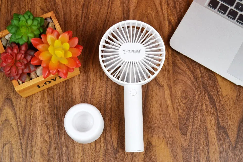 ORICO FH1 white portable USB rechargeable fan with three-speed settings on a desk.