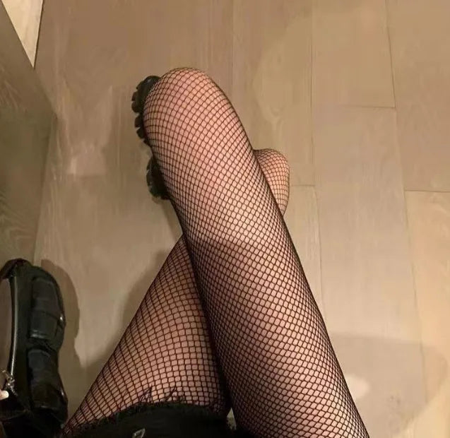 Women's black and white mesh stockings showing large, medium, and small net patterns on a leg.