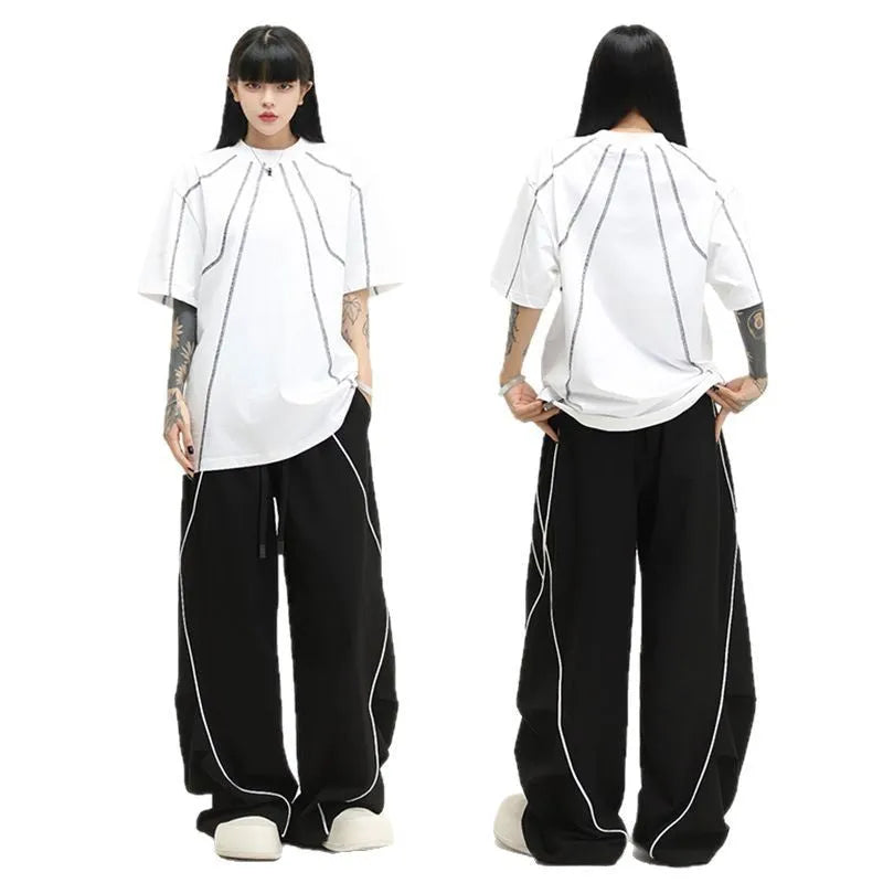 Black and white striped wide-leg hip hop trousers with front pleats on a mid-waist.