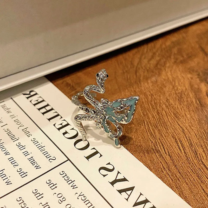 Copper butterfly women's ring with drip oil finish in an open-loop design.