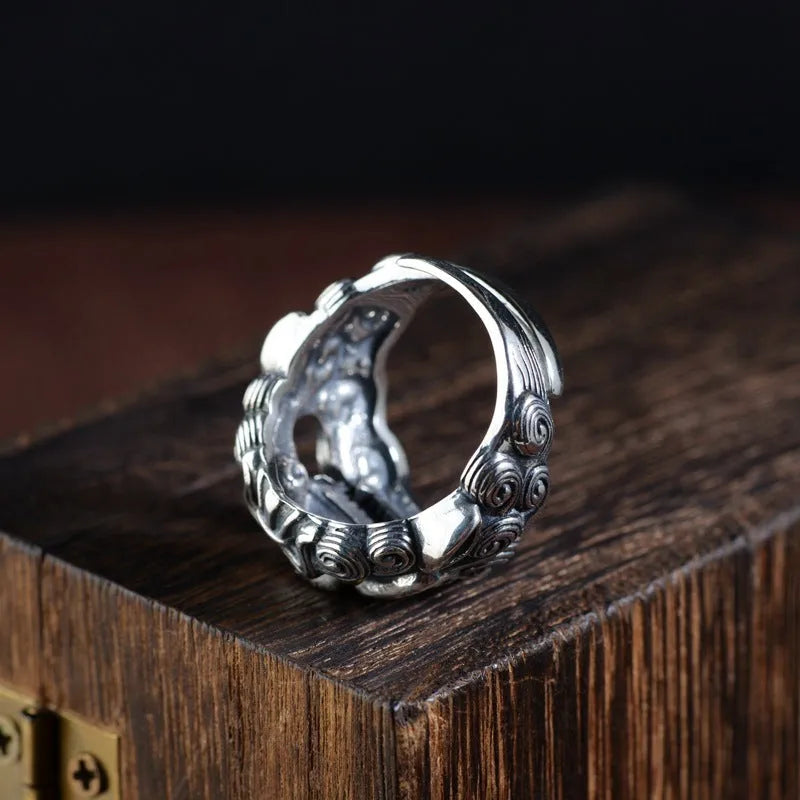 Silver open ring with domineering jibeast pattern showing animal zodiac modelling details