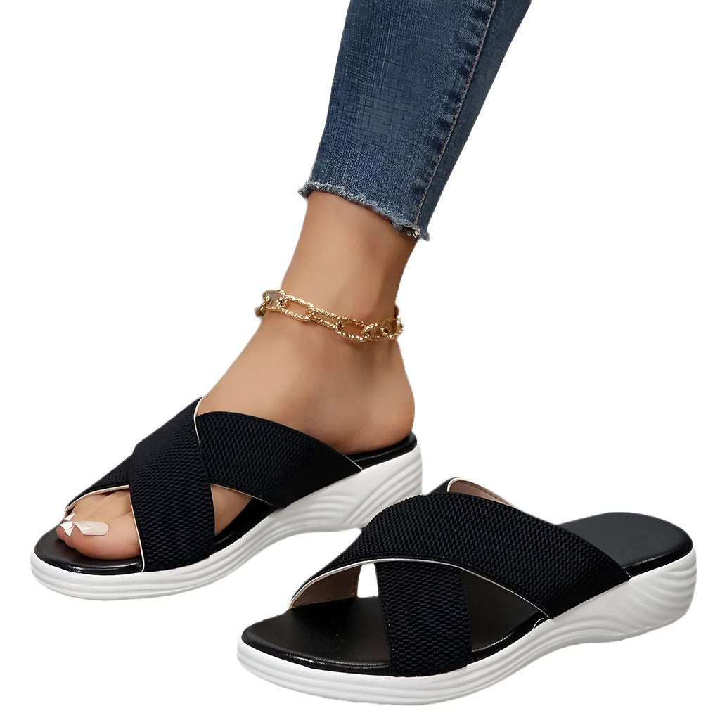 Women's black peep-toe wedge slippers with thick rubber sole showing fish mouth scaffold design