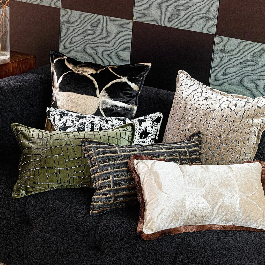 Black gold abstract pattern decorative cushion with removable cover in three size options on a sofa.