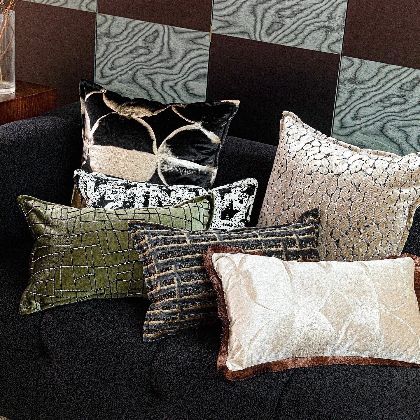 Black gold abstract pattern decorative cushion with removable cover in three size options on a sofa.