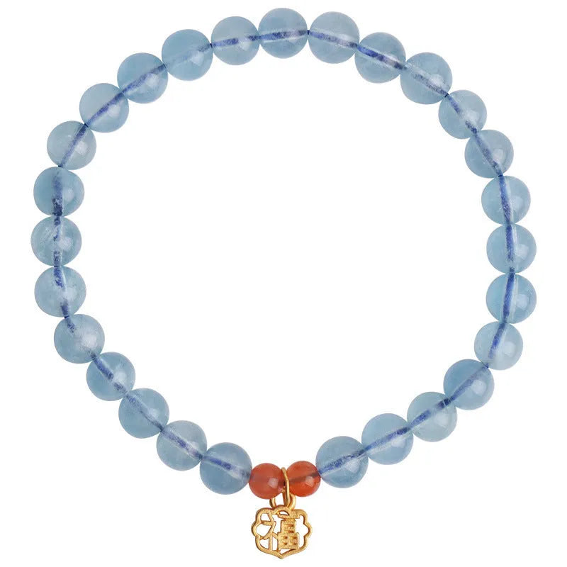 Women's crystal bracelet with ice translucent aquamarine 8mm round beads and sequin detailing on a white background.