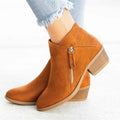 Women's suede ankle boots with a side zip and chunky heel in beige, shown from the side.