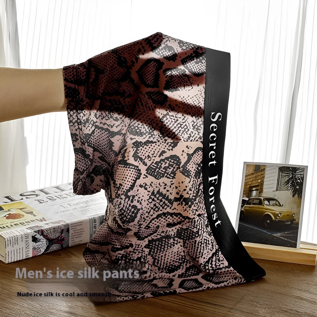 Men's loose-fit polyester boxer shorts in black, shown laid flat to display the thin fabric and mid-waist design.