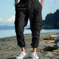 Men's loose fit linen trousers with ankle-tied hem and multiple pockets in army green.