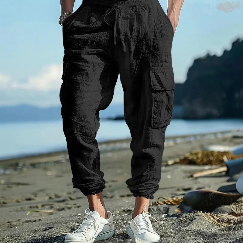 Men's loose fit linen trousers with ankle-tied hem and multiple pockets in army green.