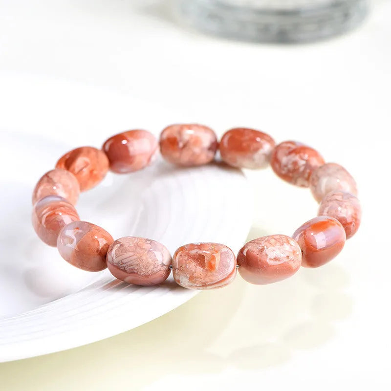 Natural cherry agate barrel bead bracelet with Ruyi elements measuring 10x14mm
