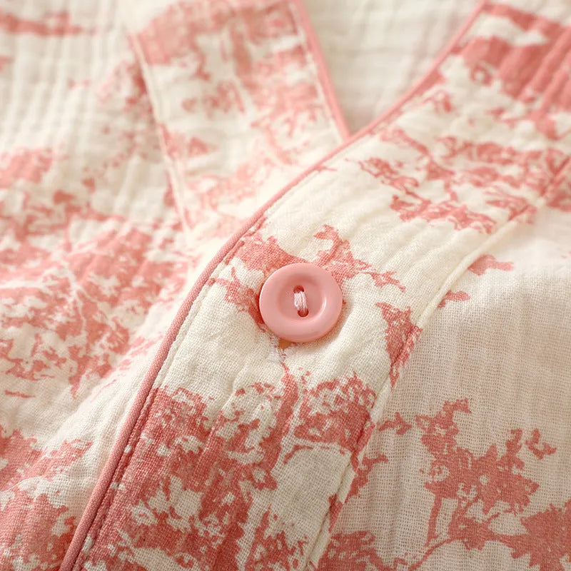 Women's pink pure cotton gauze long sleeve lounge suit with matching trousers on a hanger.