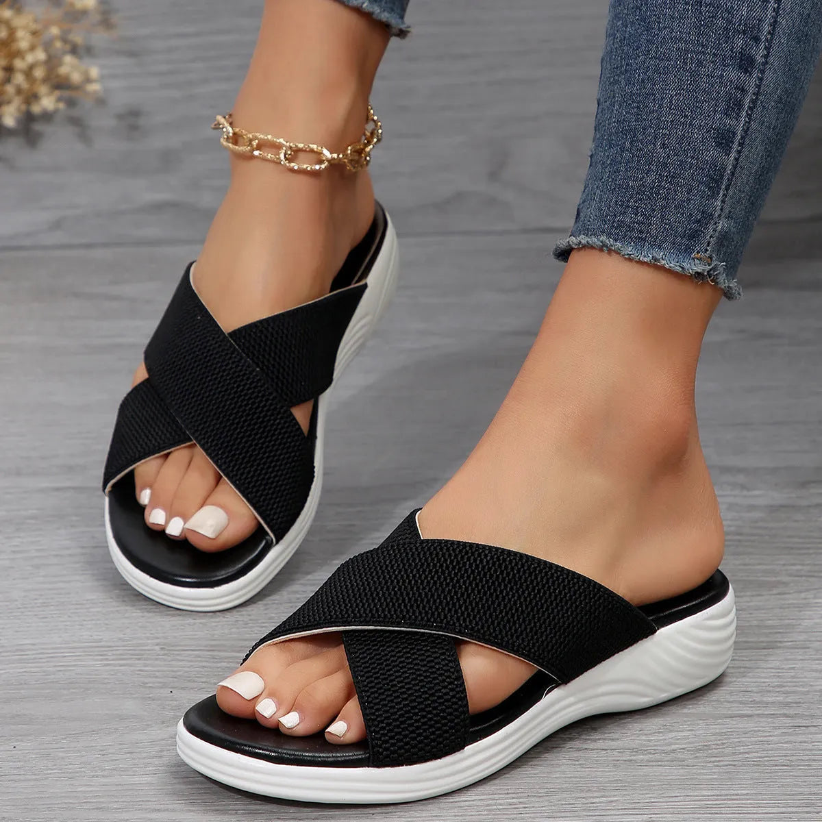 Women's black peep-toe wedge slippers with thick rubber sole showing fish mouth scaffold design