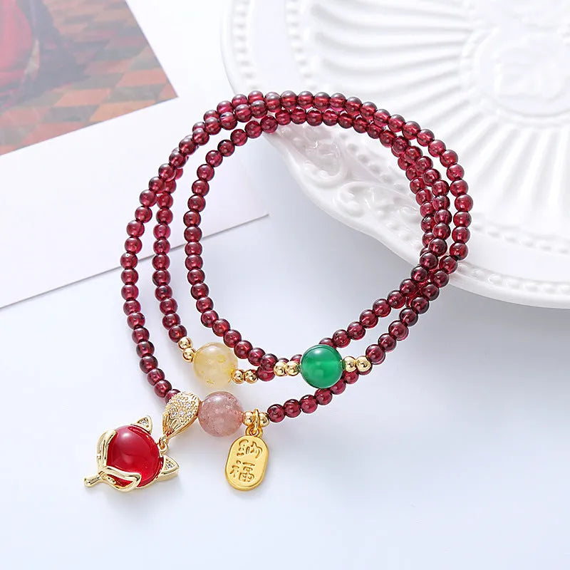 Purplish red garnet fox charm bracelet with adjustable cord fastening for women