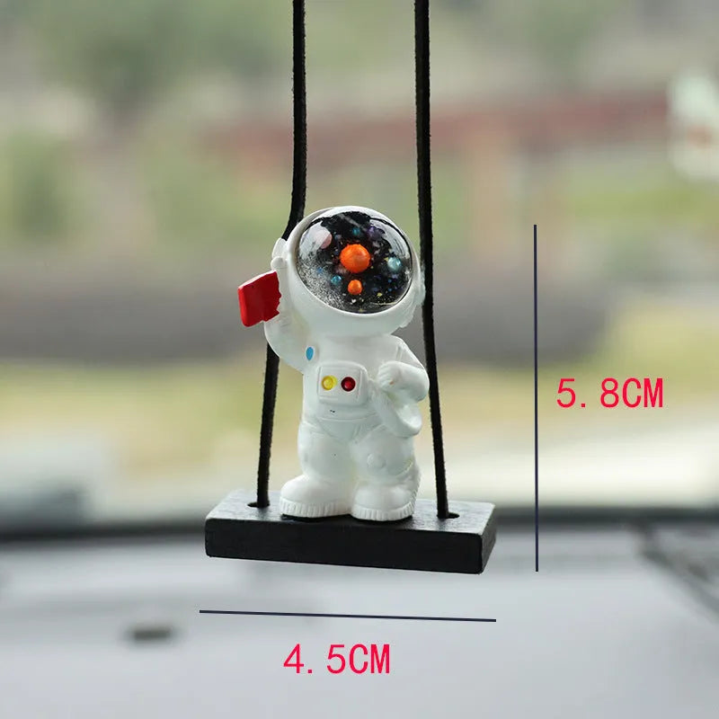 Resin astronaut car pendant showing five colour options including telescope and red flag designs